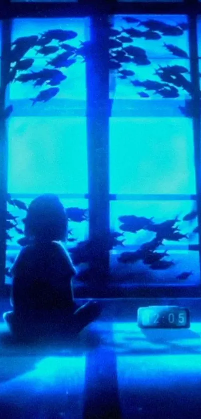 Silhouette in a blue room with fish swimming by the window.