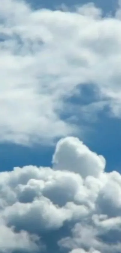 Fluffy white clouds against a vibrant blue sky.