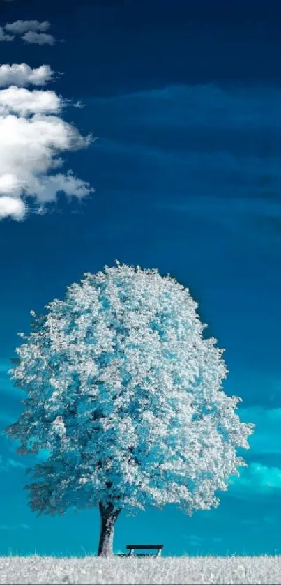 Peaceful landscape with a lone tree under a vibrant blue sky.