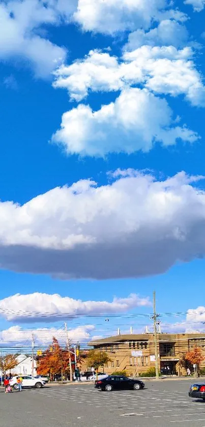 Mobile wallpaper featuring blue sky with clouds, parking lot view.