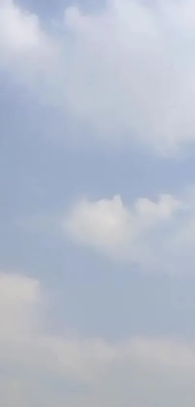 Light blue sky with soft white clouds, creating a serene backdrop.