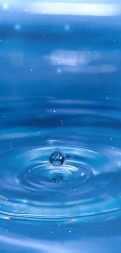 Serene blue water ripple with a single droplet in the center.