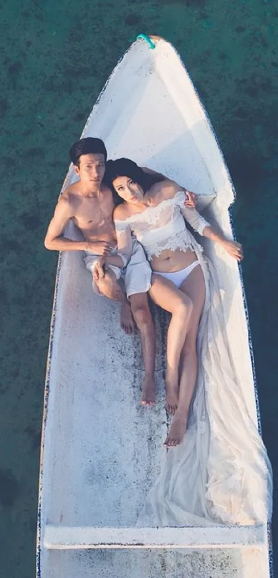 Aerial view of a couple relaxing on a boat in calm blue waters.