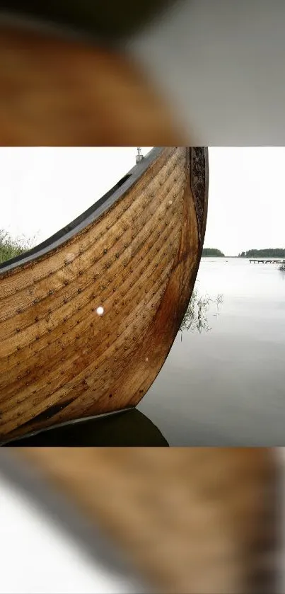 Wooden boat on calm lake with serene background.