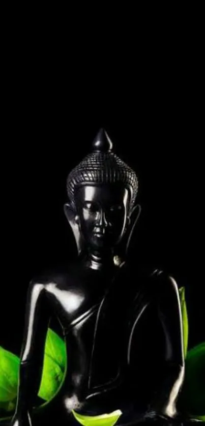 Black Buddha statue with green leaves on a dark background.