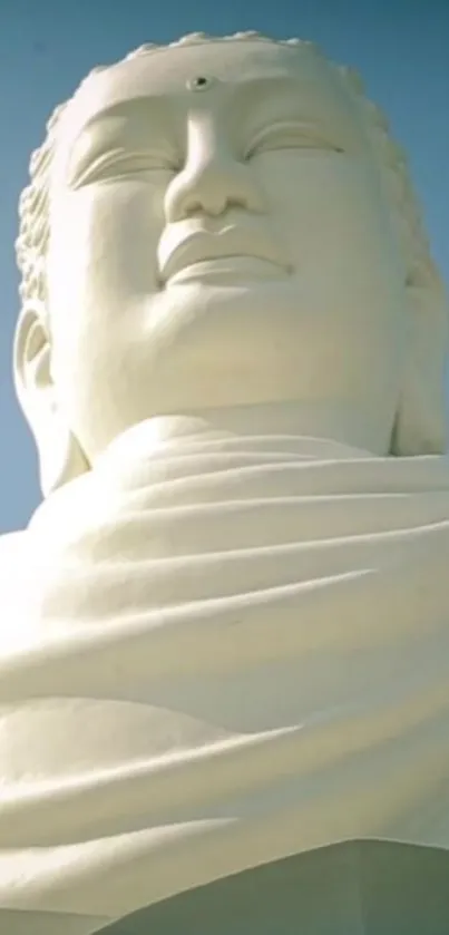 Serene Buddha statue under light blue sky