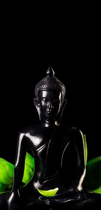 Black Buddha statue with bright green leaves on a black background.