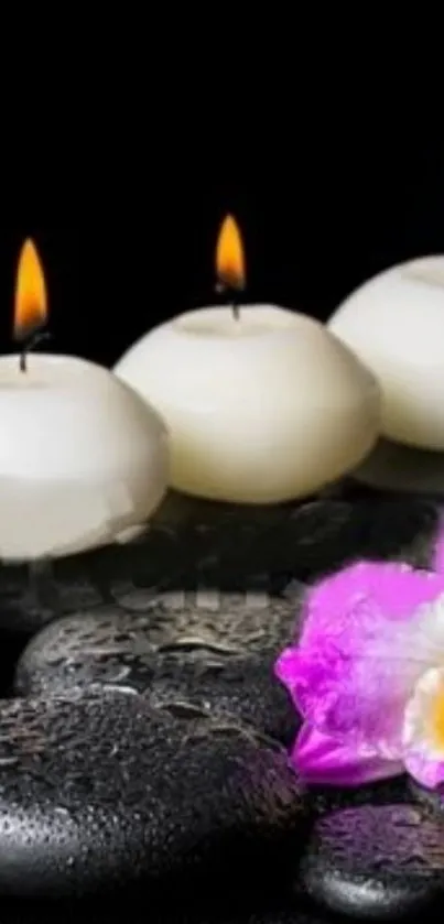 Mobile wallpaper with candles, stones, and a pink orchid on a black background.