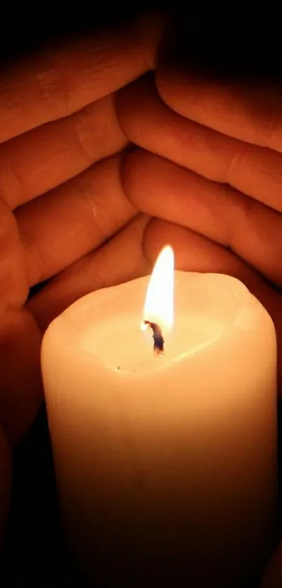 Glowing candle embraced by hands, creating a serene, peaceful ambiance.