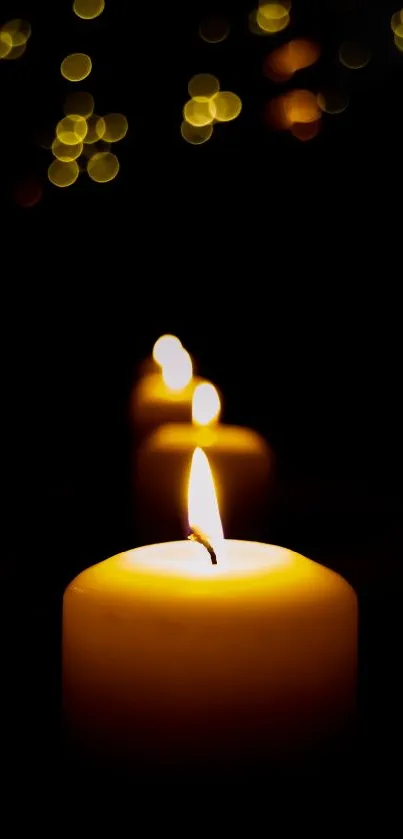 Serene candles with soft bokeh background in dark setting.