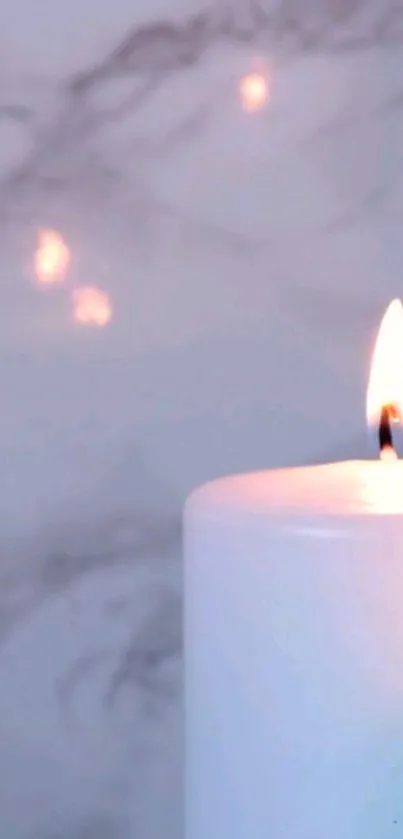 Serene candle glowing against marble background.