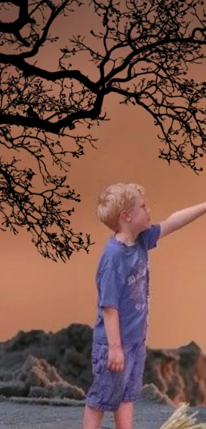 Child reaching under autumn branches with orange sky.