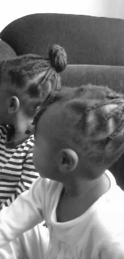 Two children with braided hair in monochrome.