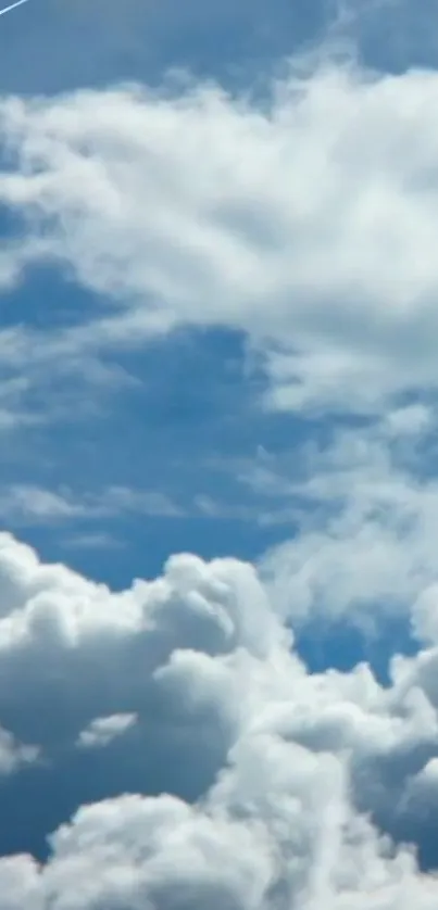 Fluffy white clouds against a vibrant blue sky.