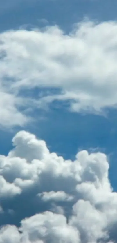 Fluffy white clouds against a serene blue sky in a mobile wallpaper.