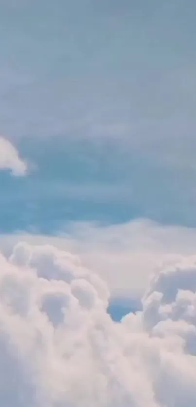 Serene sky with fluffy white clouds against a blue backdrop.