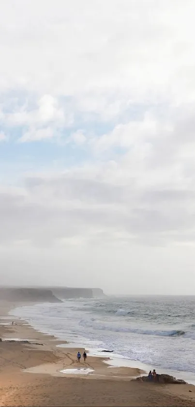 Serene beach scene with ocean and sky.