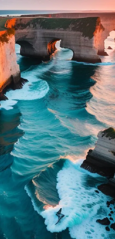 A stunning sunrise over teal ocean waves and dramatic coastal cliffs.