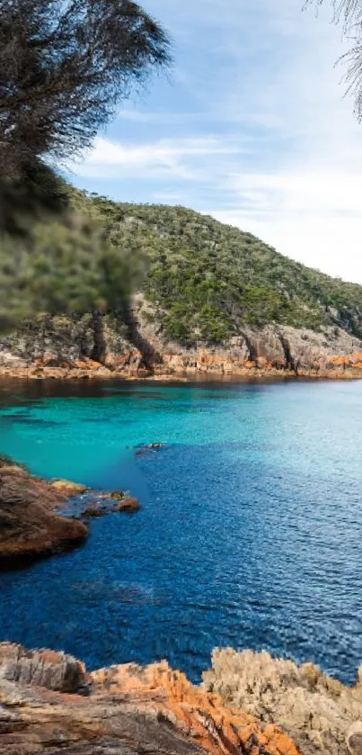 Serene coastal landscape with blue ocean and rocky cliffs.