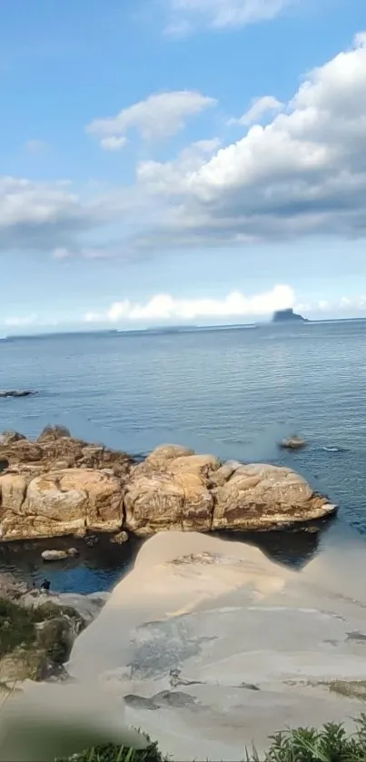 Coastal landscape with rocks and blue sky.