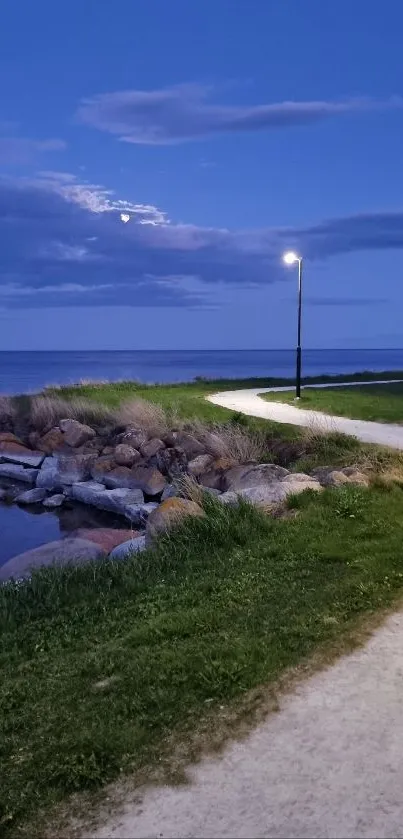 Coastal pathway at dusk under a blue sky.