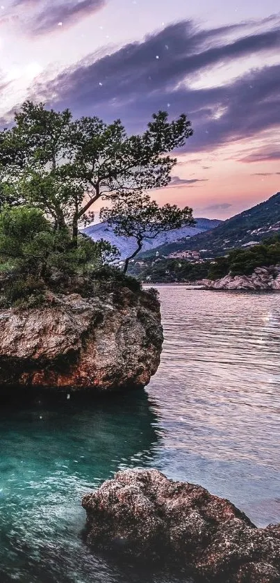 Serene coastal rock at sunset with tranquil waters and vivid sky.