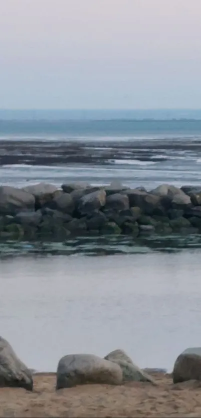 Tranquil coastal landscape with rocks and sea.