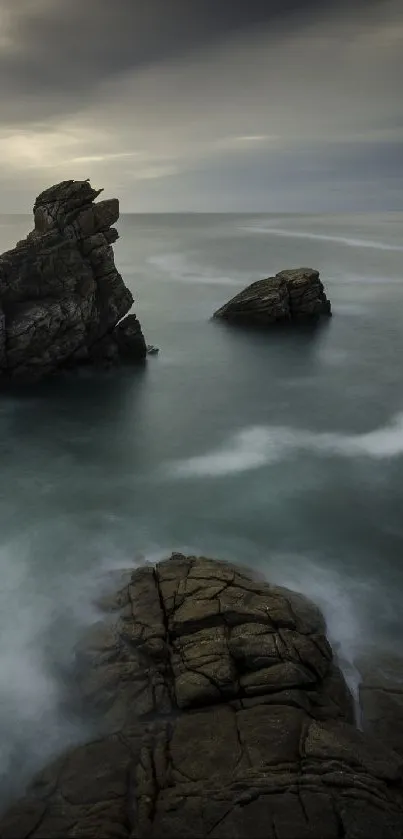 Serene coastal rockscape with tranquil waves and cloudy sky.