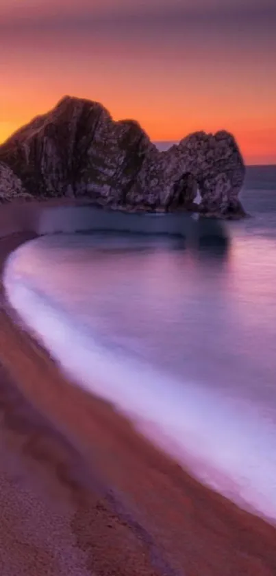 Serene coastal sunset with orange hues over the calm ocean.