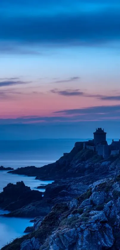 Serene coastal sunset with vibrant blues and pink hues over rocky shore.