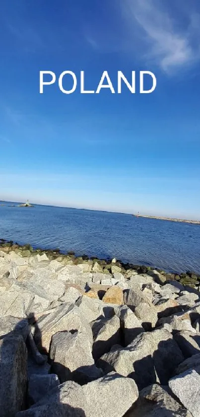 Serene coastal landscape wallpaper with sky and rocks.