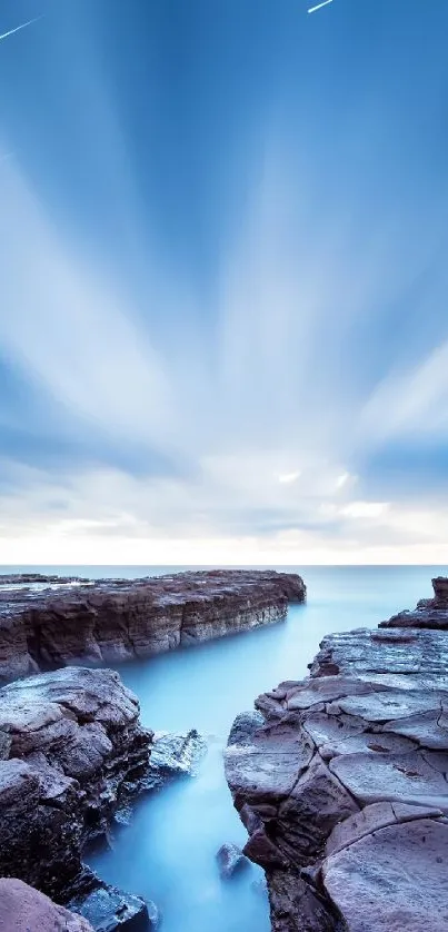 Serene coastal view with rocky shores and vibrant blue sky.