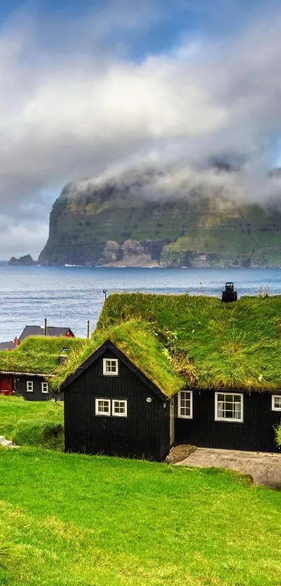 Serene coastal village with lush green roofs and misty mountains.