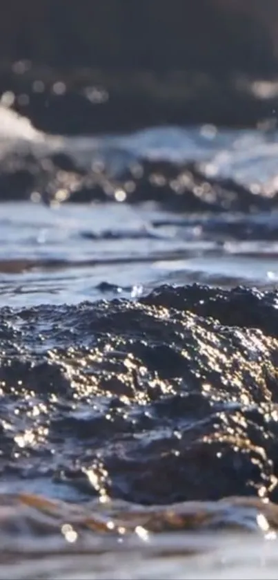 Serene view of waves on a rocky shore at sunset.