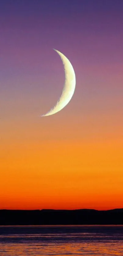 Tranquil crescent moon over a vivid sunset sky.