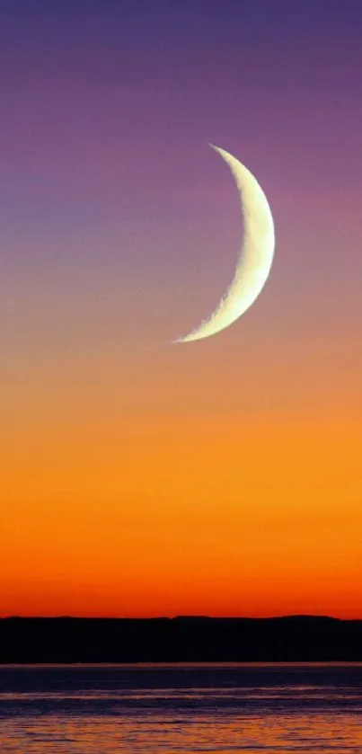 Serene crescent moon over a vibrant sunset horizon.