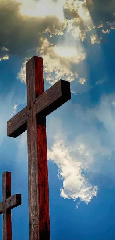 Serene wooden crosses under a colorful sky with clouds and sunlight rays.