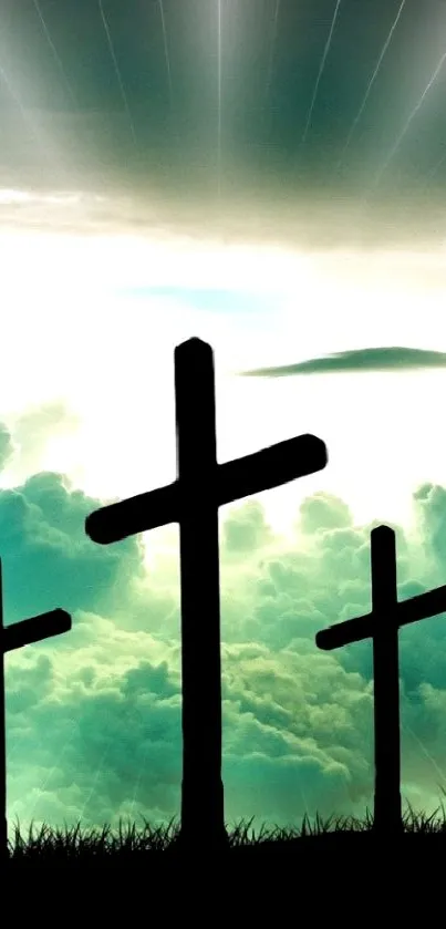 Crosses silhouetted against a sunrise and clouds for mobile wallpaper.