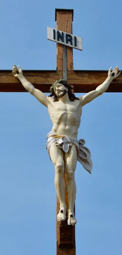 Crucifix under a serene blue sky, symbolizing peace.