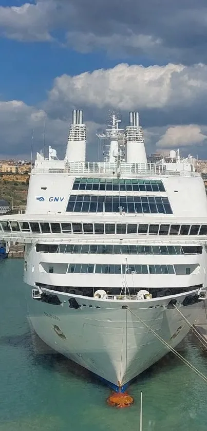 Cruise ship docked under a blue sky.