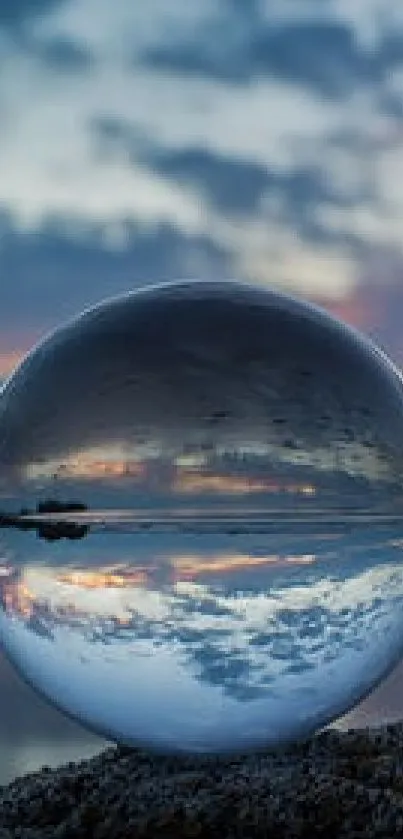 Crystal ball reflecting a serene sunset over calm waters.