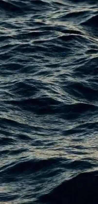 Dark blue ocean waves wallpaper for a serene mobile background.