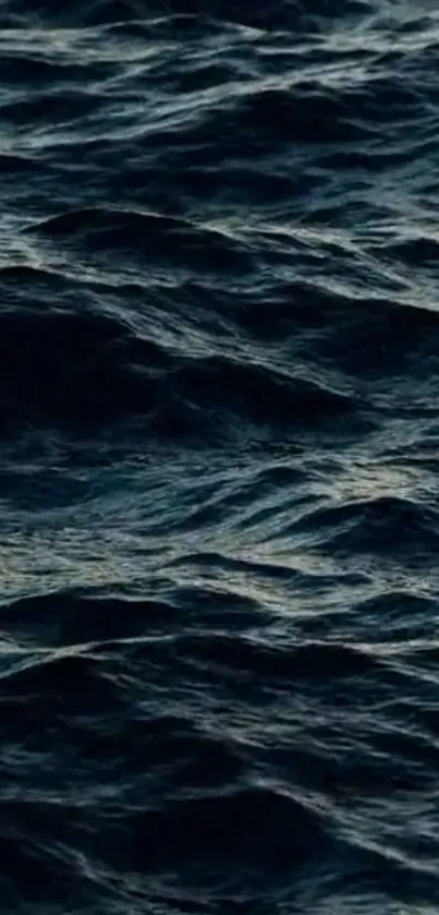 Dark blue ocean waves with textured ripples.