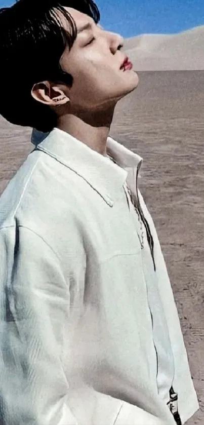 Person in white shirt standing calmly in a vast desert landscape.