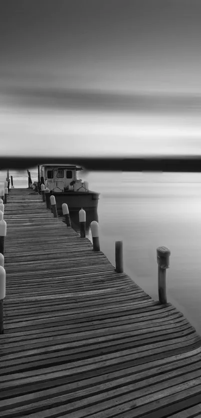 Black and white wallpaper of a serene dock extending into a calm lake.