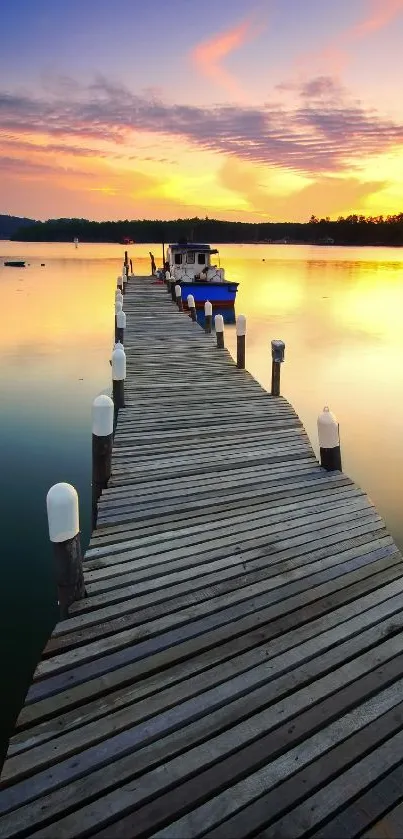 Sunset over a lake with a wooden dock leading to a boat.