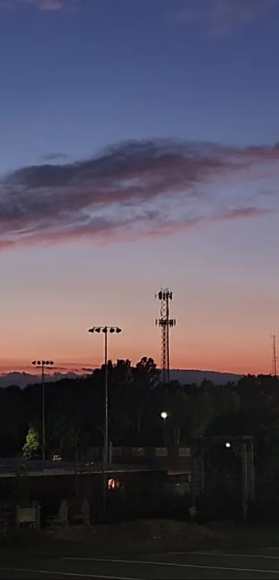 Beautiful sunset cityscape with lights illuminating the evening sky.