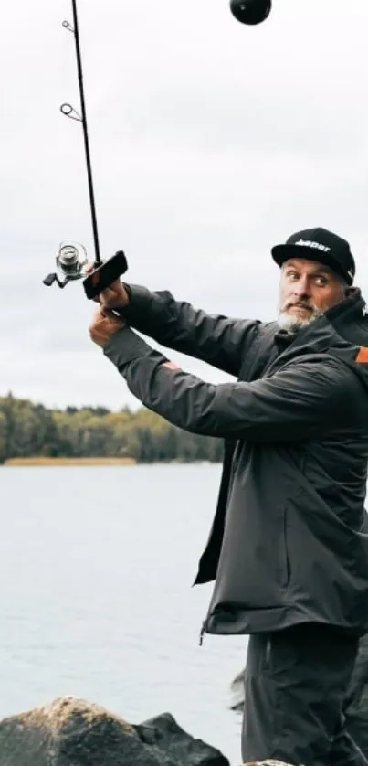 Man fishing by rocky lake in nature.