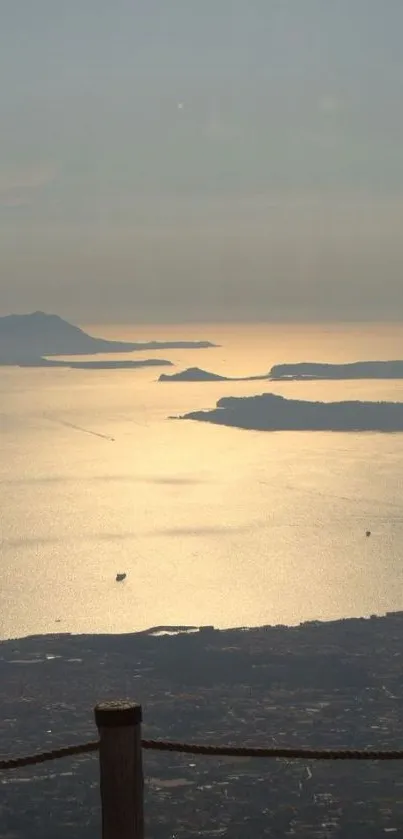 Golden sunset over a serene ocean with distant islands.