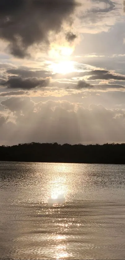 Golden sunset over lake with cloudy skies reflecting in the water.